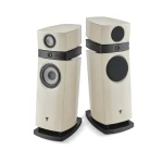 Pair of cream-colored floorstanding loudspeakers with large circular woofers and smaller drivers, mounted on black stands against a white background