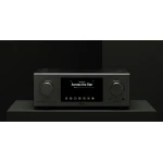 Front view of a silver hi-fi amplifier with a central touchscreen displaying the track 'Across the Star' by Samuel Kim on a dark background.