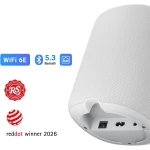 Smart speaker with WiFi 6E and Bluetooth 5.3 icons; Red Dot 2026 and RS Recommended badges shown; close-up of textured grille.