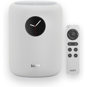 White Wiim smart speaker with a black clock face on the front, shown with its matching remote on the side.