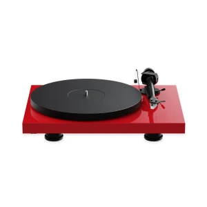 Red turntable with a large black platter and silver tonearm, viewed from the side on a white background