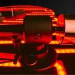 Close-up of a red rotating emergency light with a black mounting base.