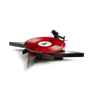 Red marbled vinyl spinning on a sleek black, angular turntable with a tonearm on the right.