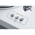 Close-up of a white turntable's speed control panel with three metal knobs labeled 33, Stby/Stop, and 45; the middle knob has a blue indicator dot.