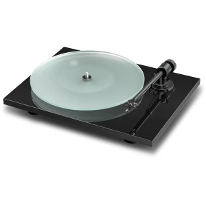 Turntable with a frosted glass record on a black acrylic base and a silver-tonearm set for playing vinyls (no needle on groove).