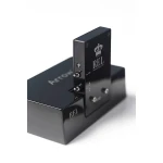 Close-up of a black REL Acoustic audio module with chrome connectors on a glossy base (brand logo visible).