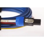 Speakon NL4FC audio connector on a blue cable with yellow wire visible.