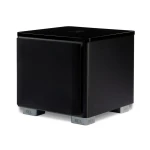 Black cube-shaped subwoofer with a glossy top, standing on four silver feet labeled REL.