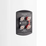 Black Criterion S 230 speaker terminal plate with four banana plug terminals mounted on a white wall surface