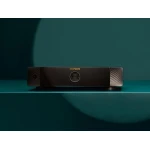 Marantz stereo amplifier on a teal surface with a circular control dial at center and textured sides.
