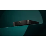 Marantz black audio amplifier on a teal shelf with dramatic lighting, front view