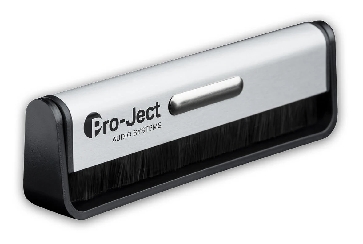 pro-ject-brush-it - Enigma High Fidelity Audio Pro-Ject record cleaning brush with metal top and black bristles in a curved housing for dust removal from vinyl records (brand shown).