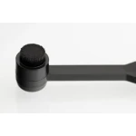 Close-up of a black spoolie brush on a handle, used for grooming eyebrows or eyelashes