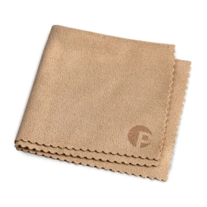 Beige microfiber cleaning cloth folded, with scalloped edges and a small logo in the corner.