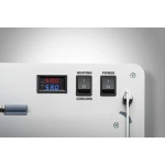 Close-up of a metallic control panel with two black toggles labeled HEATING and COOLING and a separate POWER switch; a digital dual-readout shows 58.0 °C and 58.0 °F nearby