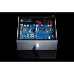 Open chassis of a silver audio device revealing a blue circuit board with capacitors, connectors, and a central metal rod; front panel has a large knob and small controls (Phono Box DS3 B).