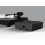 Turntable with a carbon-fiber tonearm on a black platform, connected to a black phono preamplifier labeled 'Phono Box DS3 B' on a white studio surface.