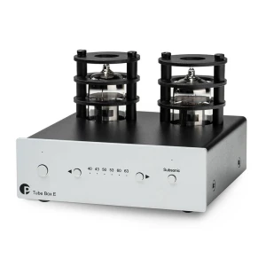 Tube amplifier with two exposed vacuum tubes on top; front panel reads 'Tube Box E' with control knobs and indicators.