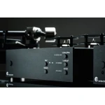 Close-up of a black audio amplifier front panel with knobs labeled Input, Subsonic, Gain dB, and Loading Ohms/Loading pF on a rack-mounted setup