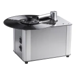 Compact desktop vinyl record cutting lathe with a spinning LP mounted on a silver metal base
