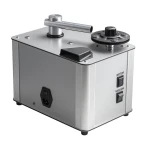 Compact benchtop vacuum pump with a silver metal body, side power inlet, and control panel labeled MOTOR and VACUUM on the front right.